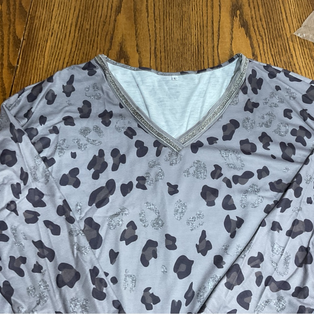 Animal print gray & black top with bling/silver glitz lining the V-neck shirt